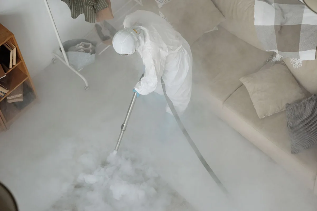 Biohazard cleanup technician in protective equipment, Borger, TX